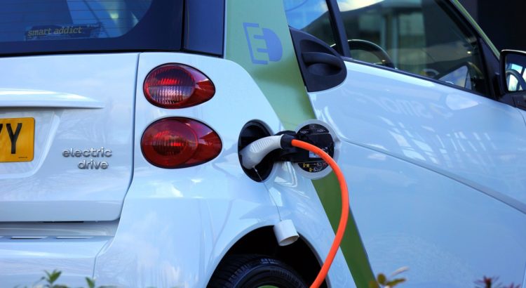 picture of a white electrical vehicle being charged
