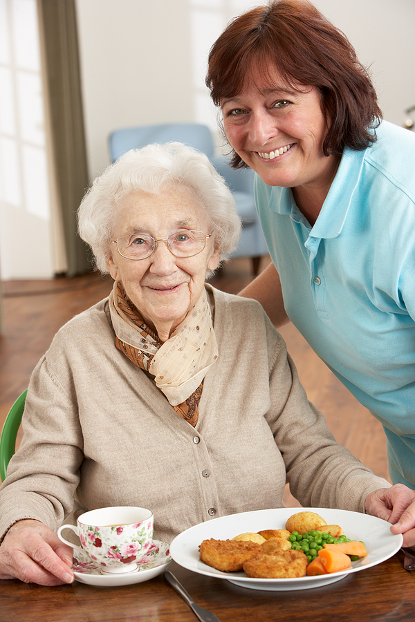 picture of senior woman being served lunch by a carer Central Bedfordshire