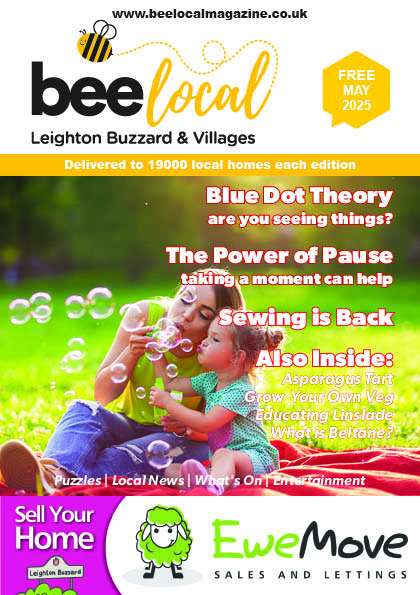 Front cover of Leighton Buzzard Magazine, Bee Local, featuring a mother and girl sitting in a park blowing bubbles