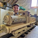 Men in Sheds Leighton Buzzard featuring a wooden hand made wooden train with smiling maker
