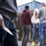 Close Up Of Teenage Boy In Urban Gang Holding Knife leighton buzzard news