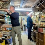 Leighton Buzzard Men In Sheds featuring crowded shed with two men working