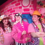 image of the cast of Three Little Pigs lost the Plot production dressed in bright pink outfits with funny pig ears